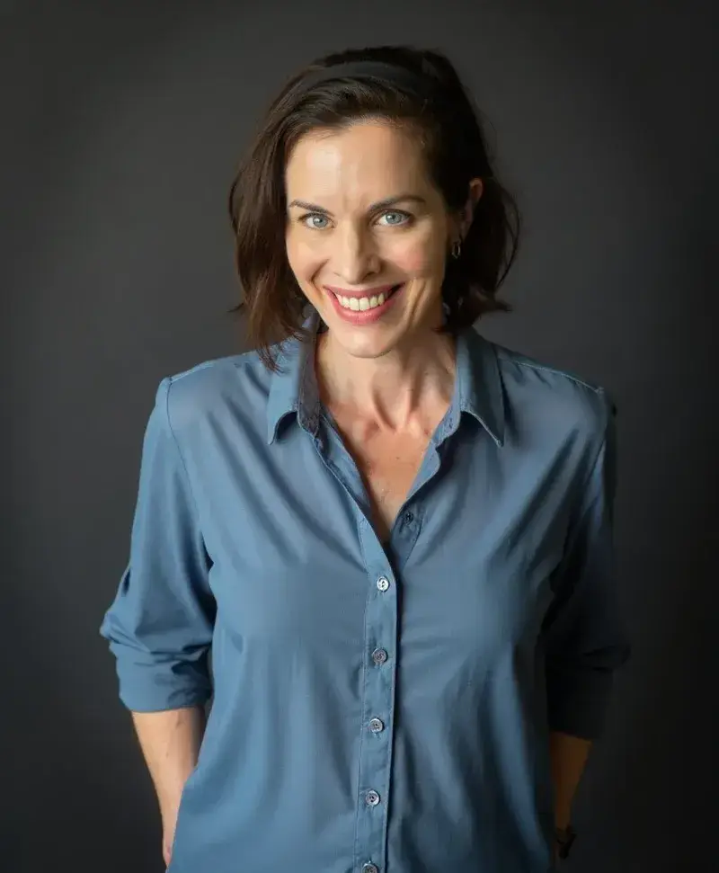 Natalie Grace smiling in a blue shirt